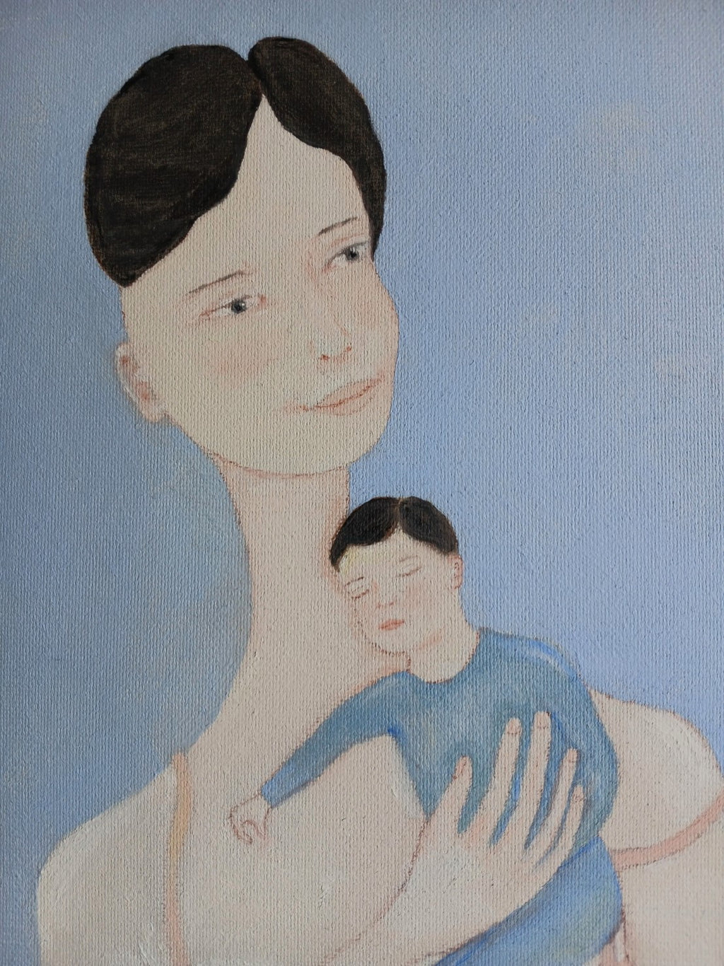Ayu and her child in her arms
