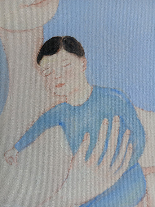 Ayu and her child in her arms