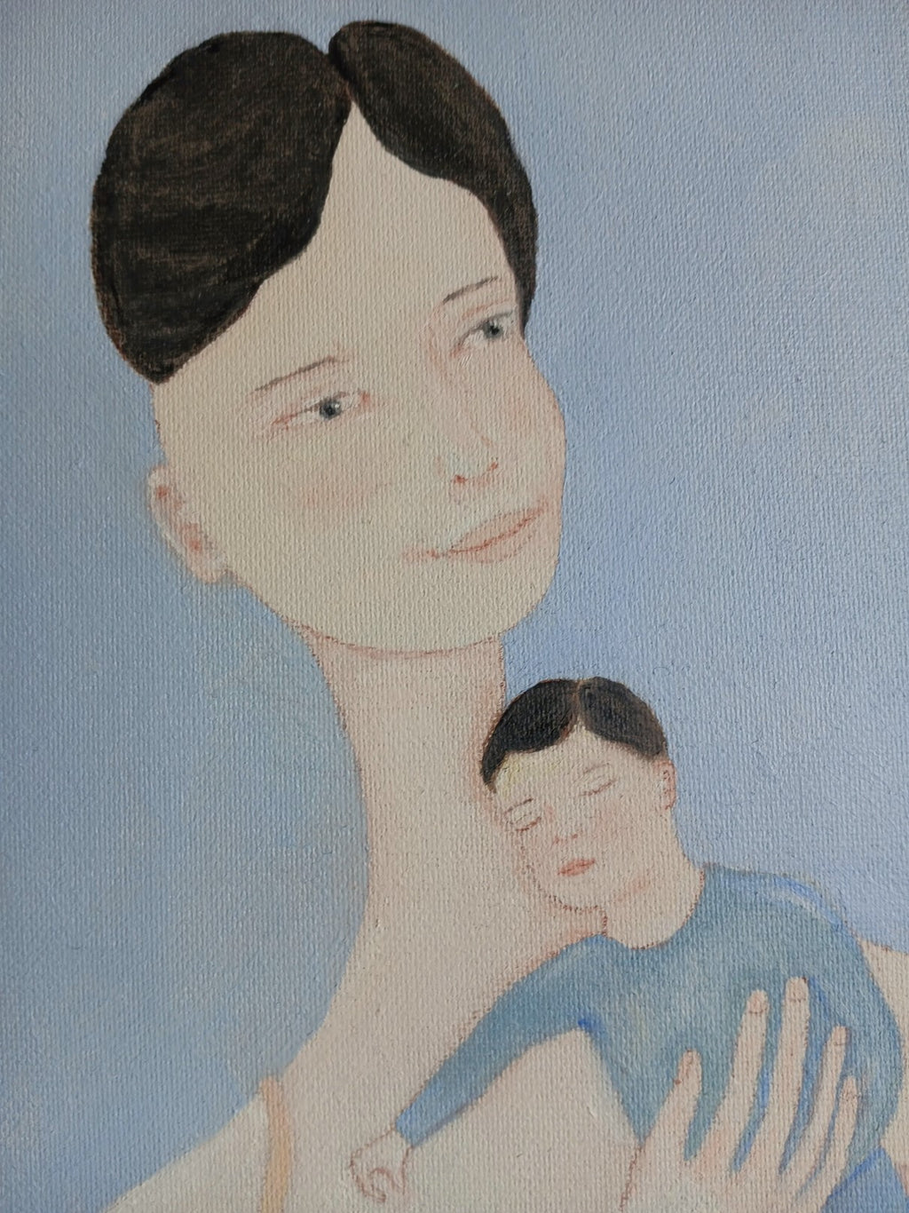 Ayu and her child in her arms